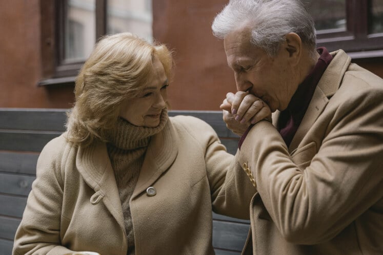 Romantic Senior Couple Sharing Tender Moment Outside Memory Care Facility Romantic Senior Couple Sharing Tender Moment Outside Memory Care Facility