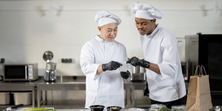 Two Chefs Reviewing Specialized Diet Menu in Kitchen at Assisted Living Facility