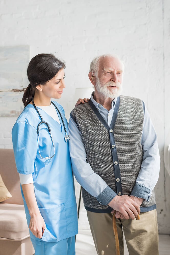 Nurse Comforting Elderly Woman at Nursing Home Oxford